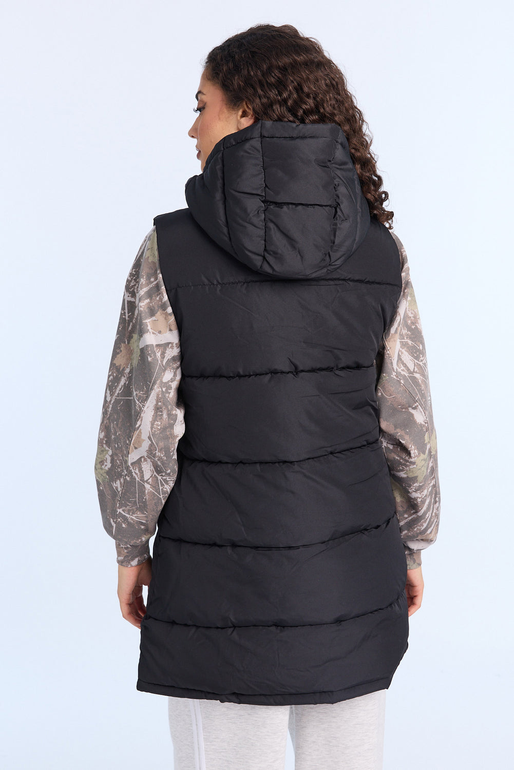 Gilet matelassée longue à capuche Gilet matelassée longue à capuche